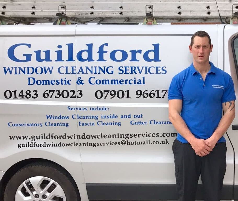 Ben Zatwardnicki, founder of Guildford Window Cleaning Services, beside the sign-written van